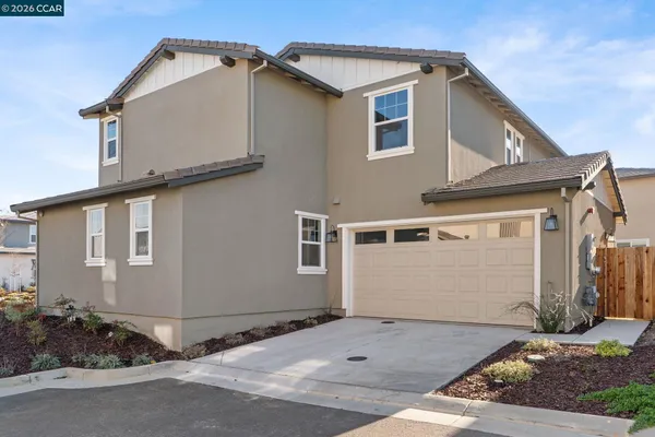 a living room with furniture and a painting on the wall
