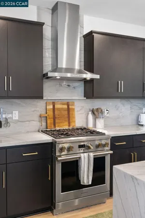 a kitchen with stainless steel appliances a stove and a sink