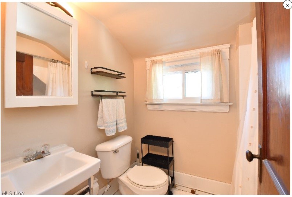 2135 Renrock Road Cleveland, OH 44118 - Photo 43 of 44 Bathroom featuring sink, lofted ceiling, and toilet