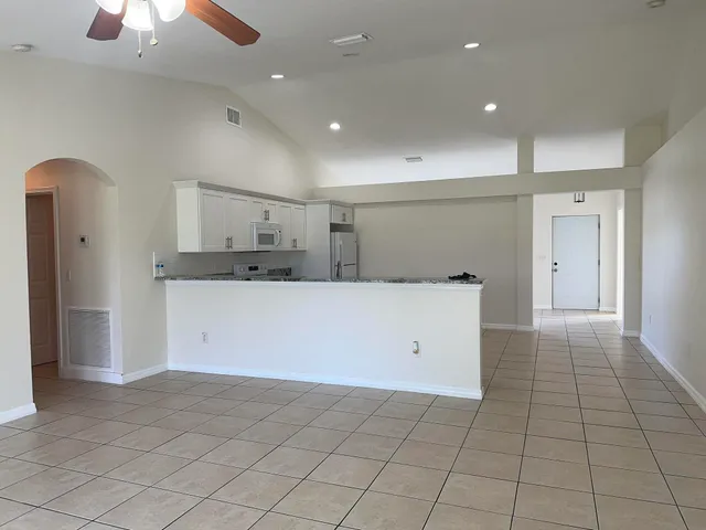 a view of kitchen with center island and stainless steel appliances