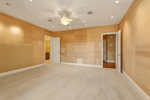 an empty room with a ceiling fan and a window