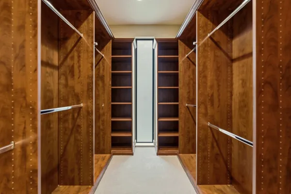 a view of a swimming pool with a lawn chairs under an umbrella
