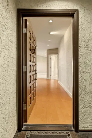a view of a livingroom with a fireplace and large windows