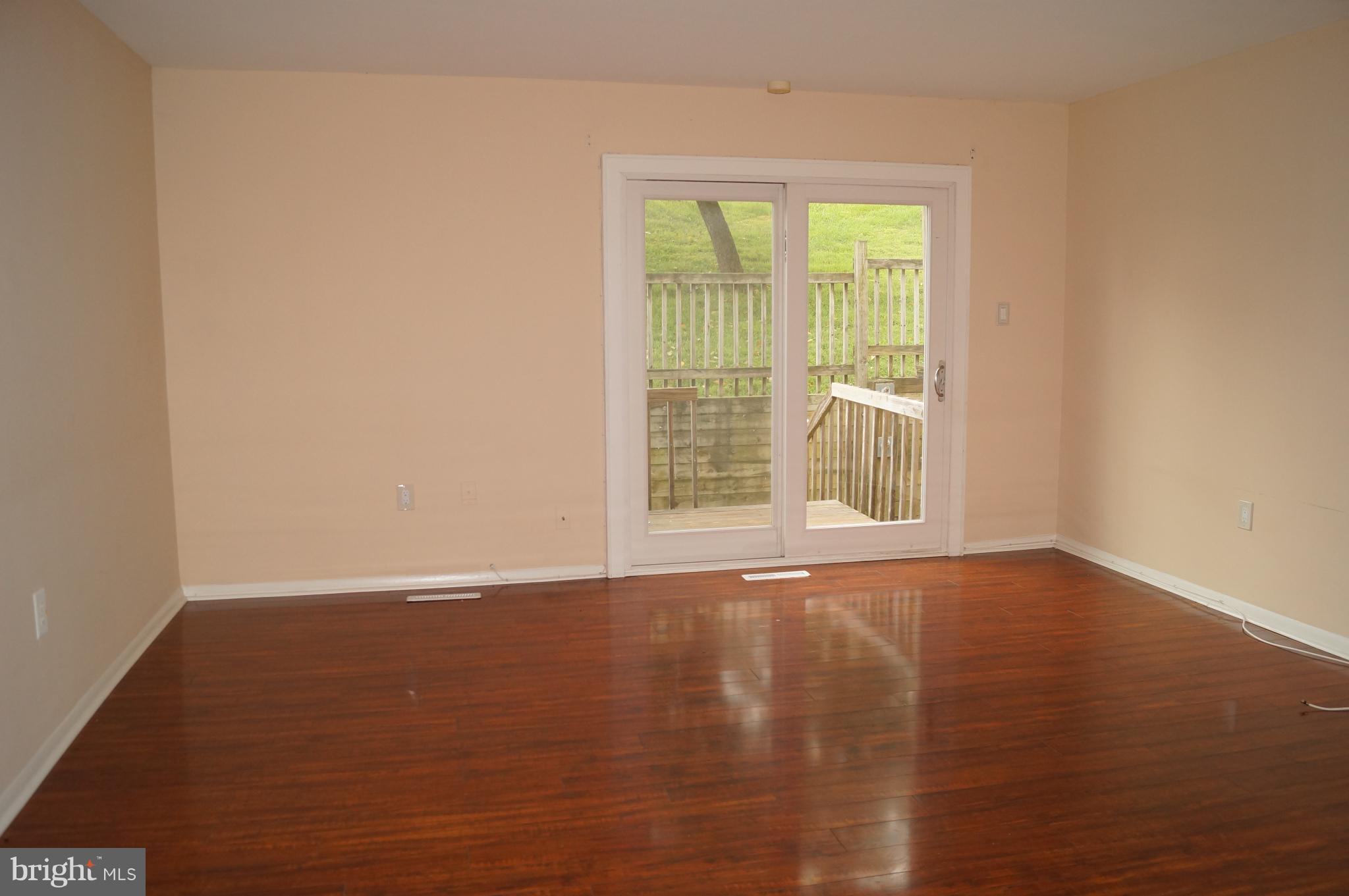42 Ritters Ridge Court Owings Mills, MD 21117 - Photo 3 of 12 a view of an empty room with wooden floor and a window