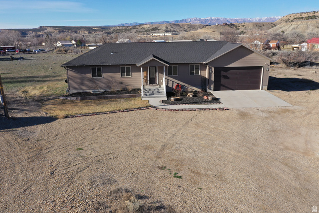 2095 West 4100 North Spring Glen, UT 84526 - Photo 29 of 35 Single story home with driveway, a mountain view, a garage, and a porch
