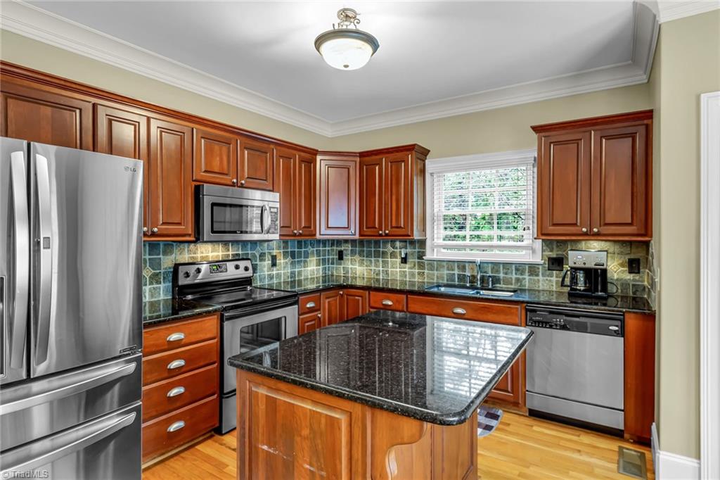5909 Ballinger Road, Unit A Greensboro, NC 27410 - Photo 11 of 41 Kitchen showing the eat in island for two.