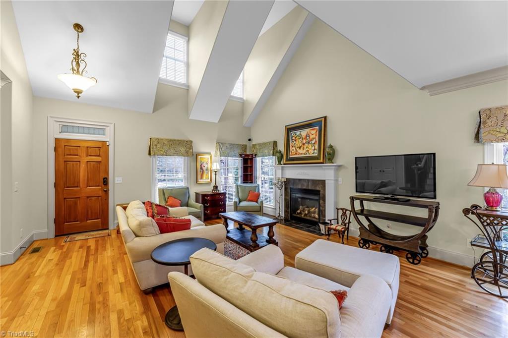 5909 Ballinger Road, Unit A Greensboro, NC 27410 - Photo 6 of 41 Great Room featuring a vaulted ceiling with windows for brightness