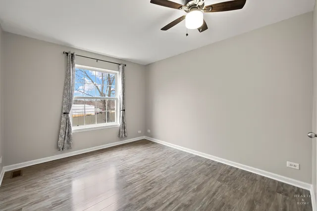 wooden floor in an empty room with a window
