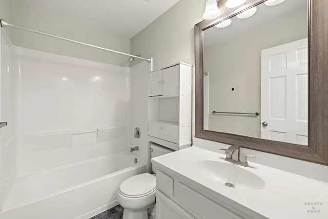 a bathroom with a sink toilet tub and shower