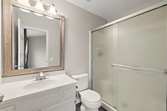 a bathroom with a sink a mirror and a toilet