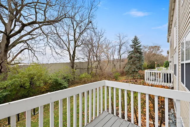 a view of a wooden deck next to a yard