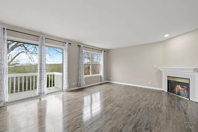 wooden floor in an empty room with a fireplace
