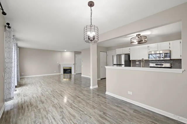 a view of a kitchen with microwave and cabinets