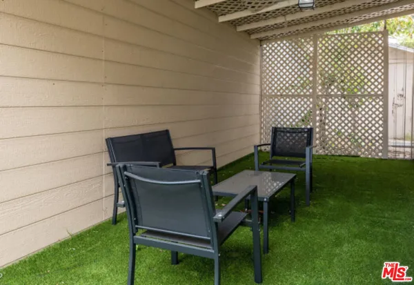 a wooden bench sitting in a backyard