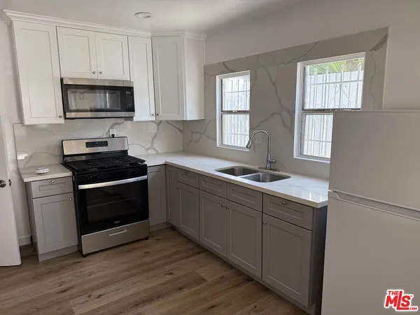 a kitchen with a sink stove and microwave