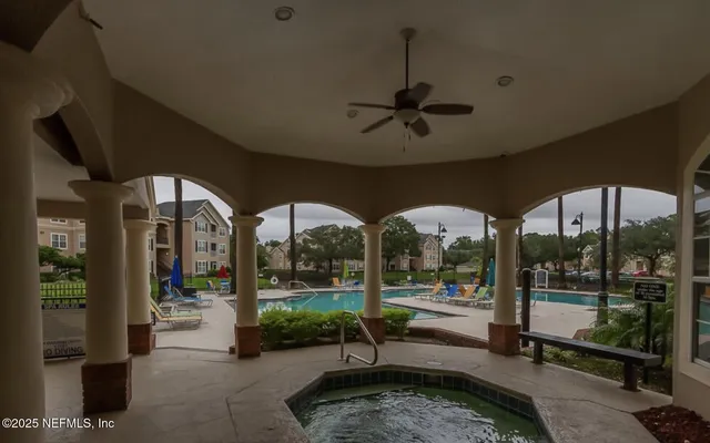 a view of swimming pool with outdoor seating and a yard