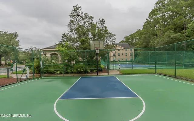 a view of a house with a yard and palm trees