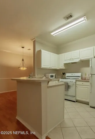 a kitchen with appliances cabinets and a sink