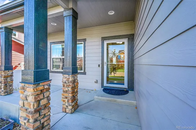 a view of front door of house with outdoor seating