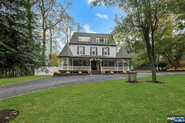 a view of a house with swimming pool and sitting area
