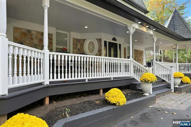 a living room with furniture and large windows