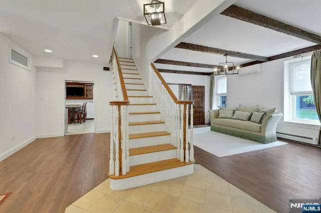 a living room with furniture and a chandelier