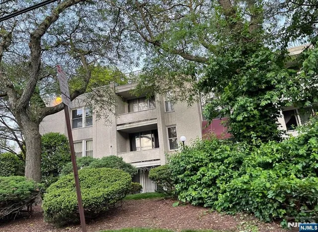 an aerial view of a house with a yard and tree s