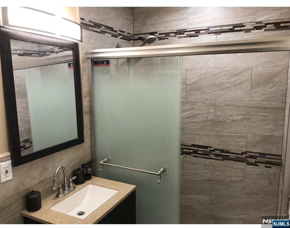 448 River Road Nutley, NJ 07110 - Photo 6 of 11 a bathroom with a sink and a mirror