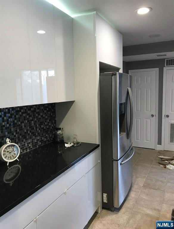 448 River Road Nutley, NJ 07110 - Photo 9 of 11 a kitchen with a refrigerator and a stove top oven