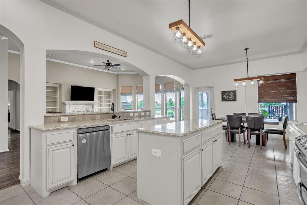 12286 Emerald Ranch Lane North Forney, TX 75126 - Photo 12 of 40 a large white kitchen with a large island in the center