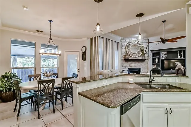 a kitchen with center island table and chairs in it