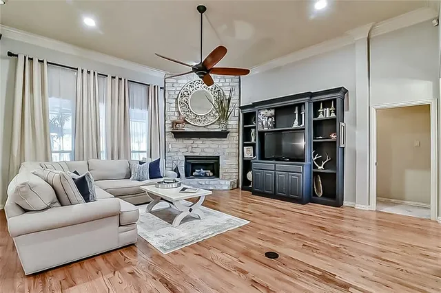 a living room with furniture a fireplace and a flat screen tv