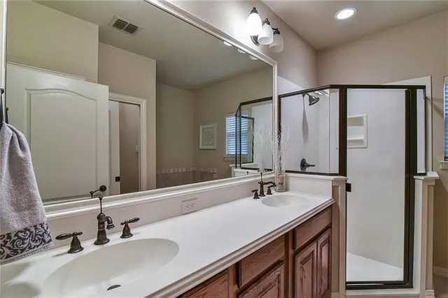 a bathroom with a sink double vanity and a mirror