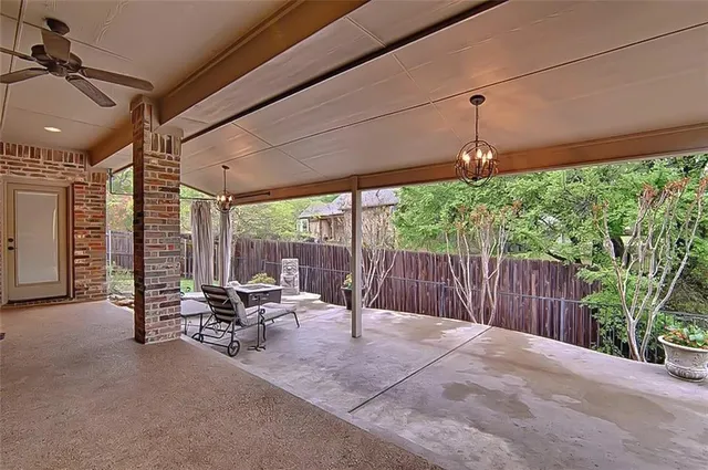 a view of a patio with table and chairs potted plants with wooden fence