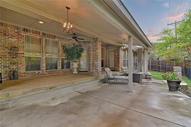 a view of a patio with dining table and chairs