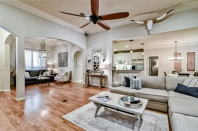 a living room with furniture and a wooden floor