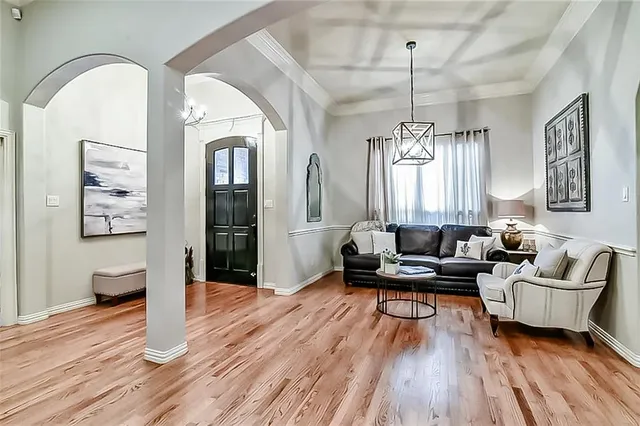 a living room with furniture and wooden floor