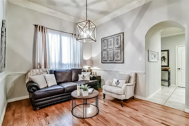 a living room with furniture and a chandelier