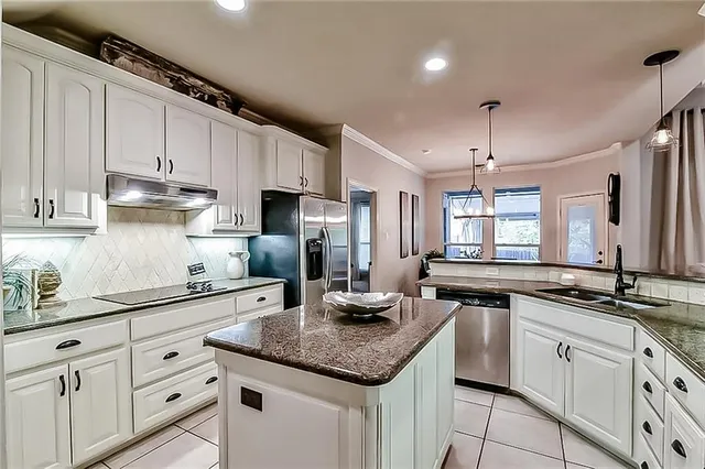 a kitchen with granite countertop kitchen island white cabinets and white appliances