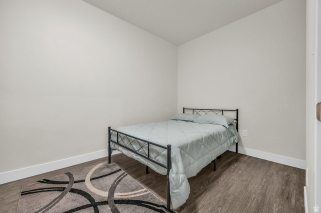 2101 North Main Street, Unit 409 Sunset, UT 84015 - Photo 11 of 18 Bedroom featuring dark wood finished floors and baseboards