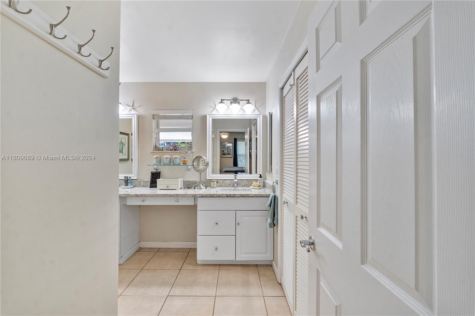 5511 Southwest 196th Lane Southwest Ranches, FL 33332 - Photo 23 of 94 a bathroom with a granite countertop sink a mirror and a bathtub