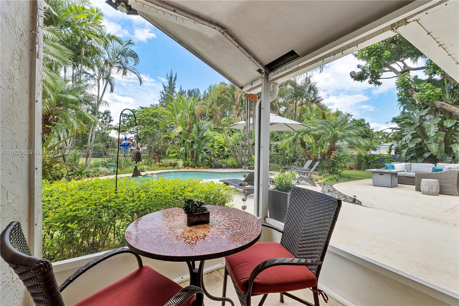 5511 Southwest 196th Lane Southwest Ranches, FL 33332 - Photo 43 of 94 a view of a patio with a table chairs and a backyard