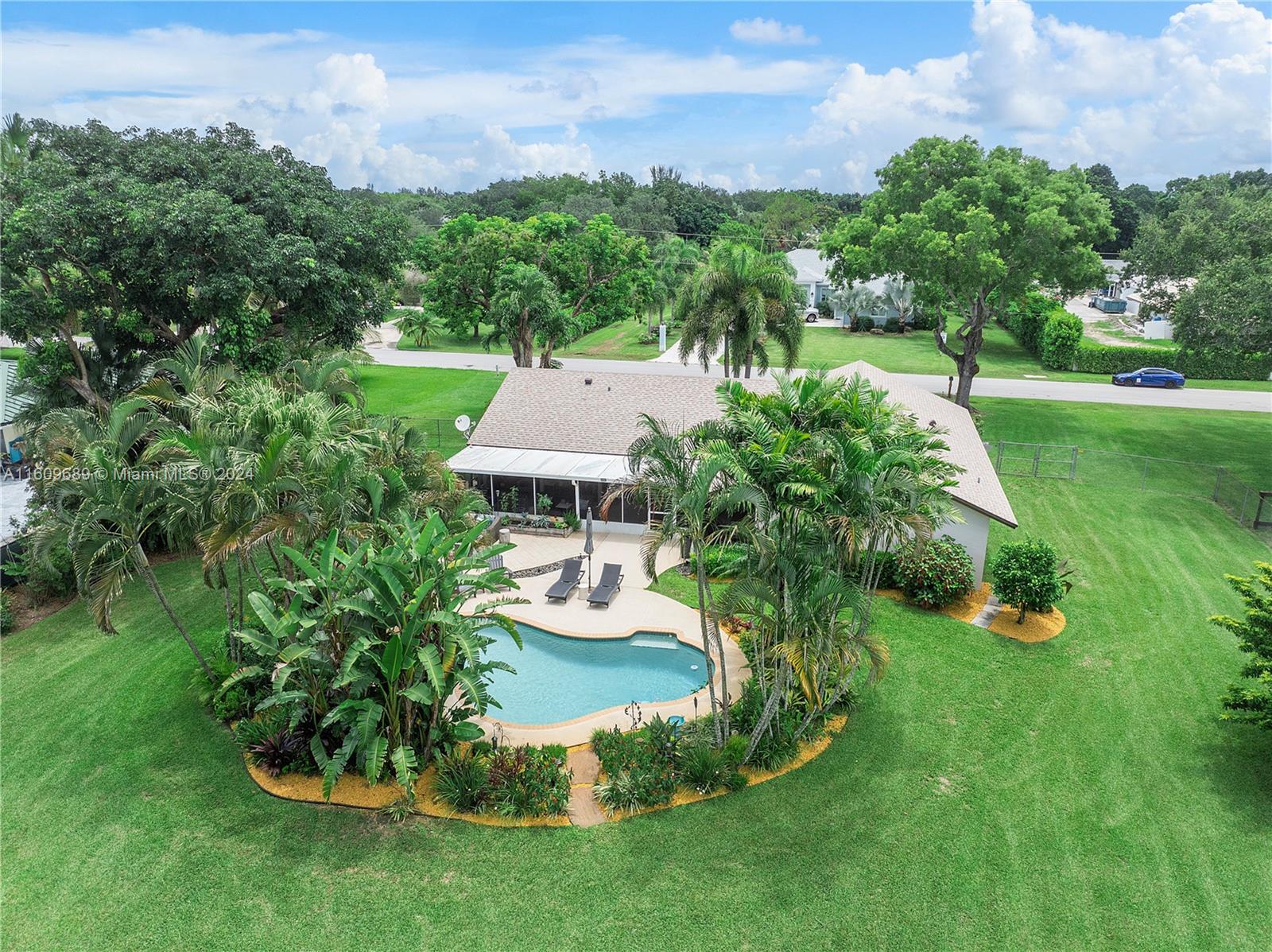 5511 Southwest 196th Lane Southwest Ranches, FL 33332 - Photo 51 of 94 a view of a house with a yard table and chairs