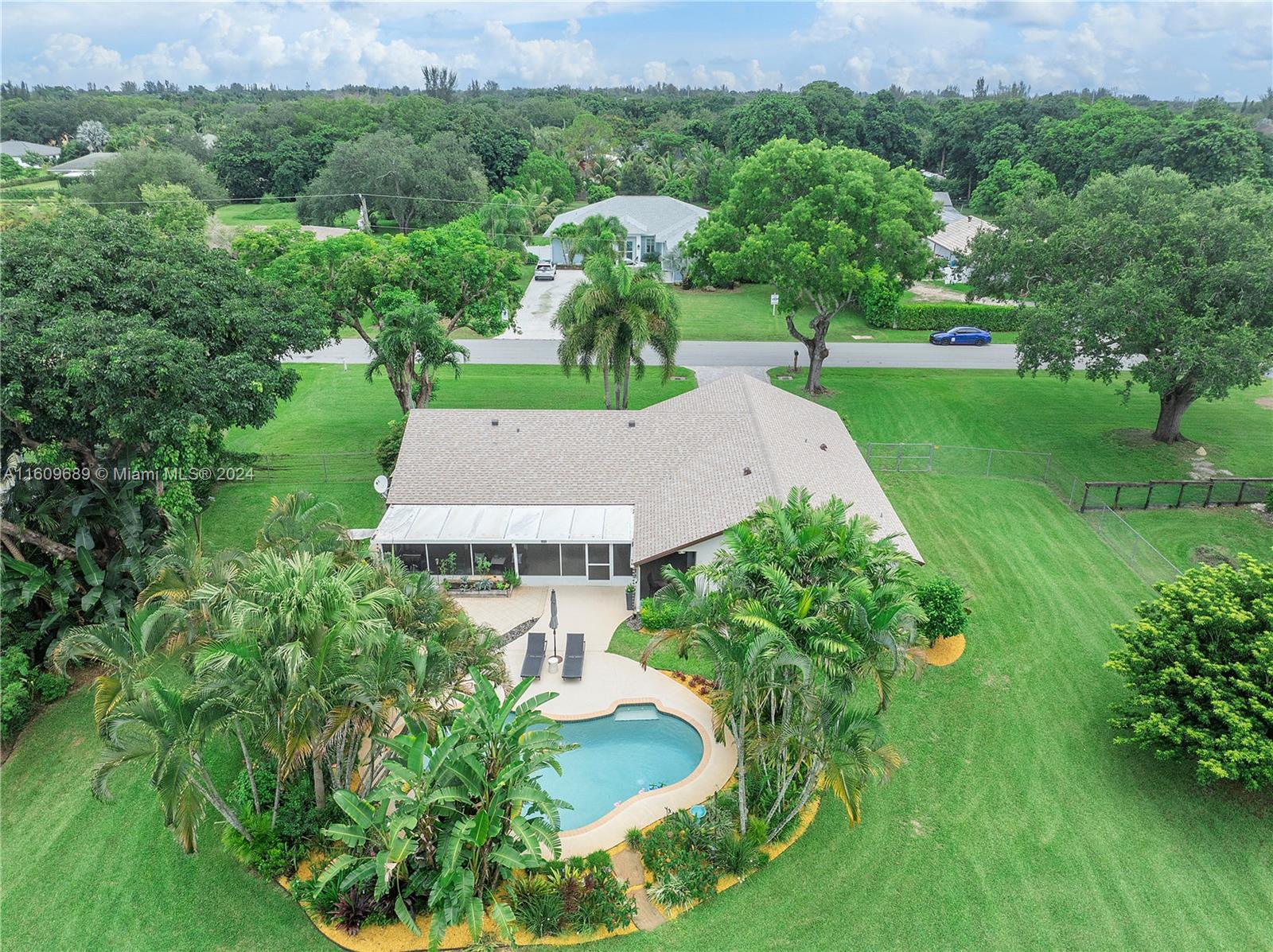 5511 Southwest 196th Lane Southwest Ranches, FL 33332 - Photo 61 of 94 a view of a garden with plants and large trees
