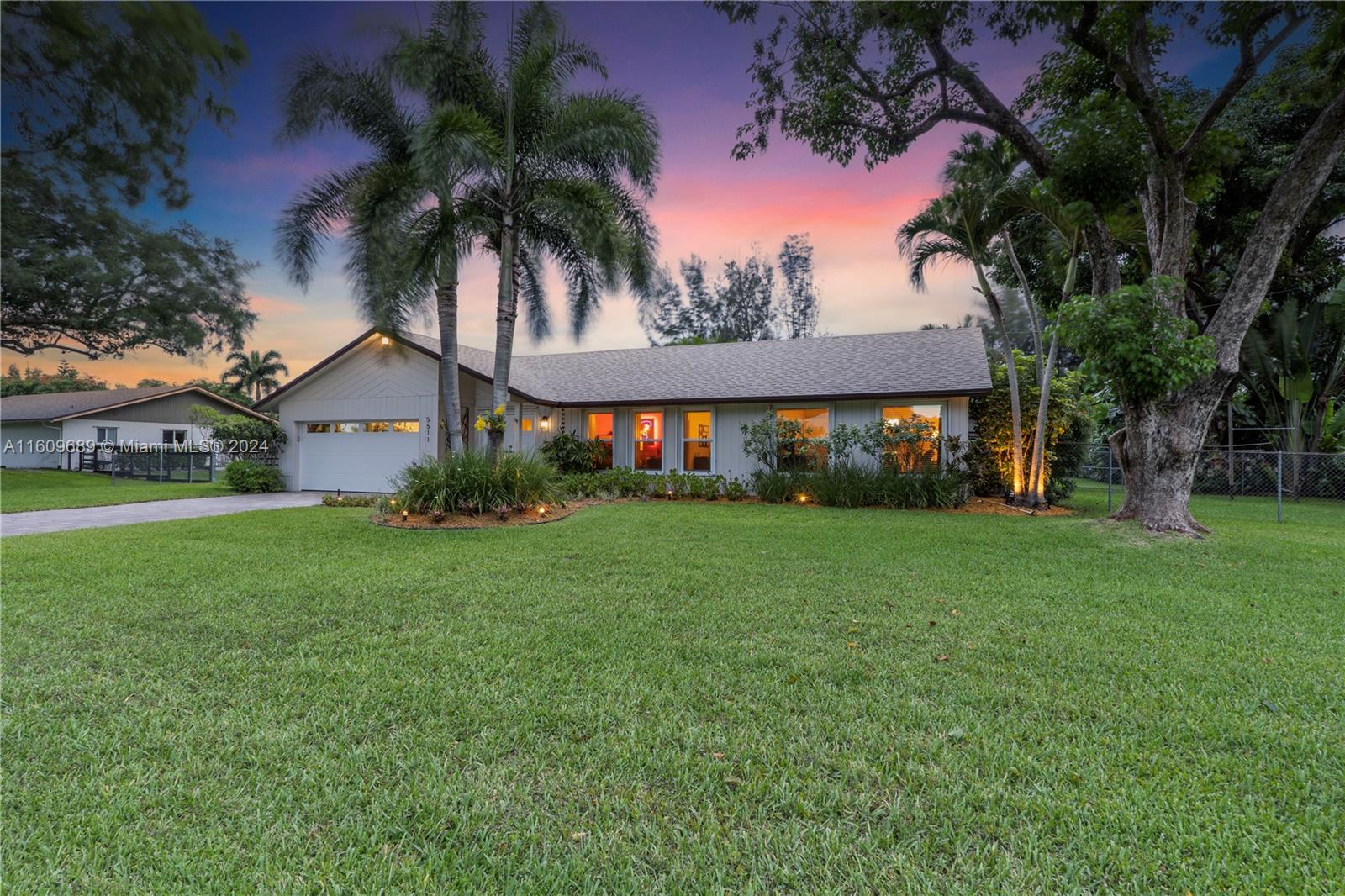 5511 Southwest 196th Lane Southwest Ranches, FL 33332 - Photo 77 of 94 a front view of house with yard and green space