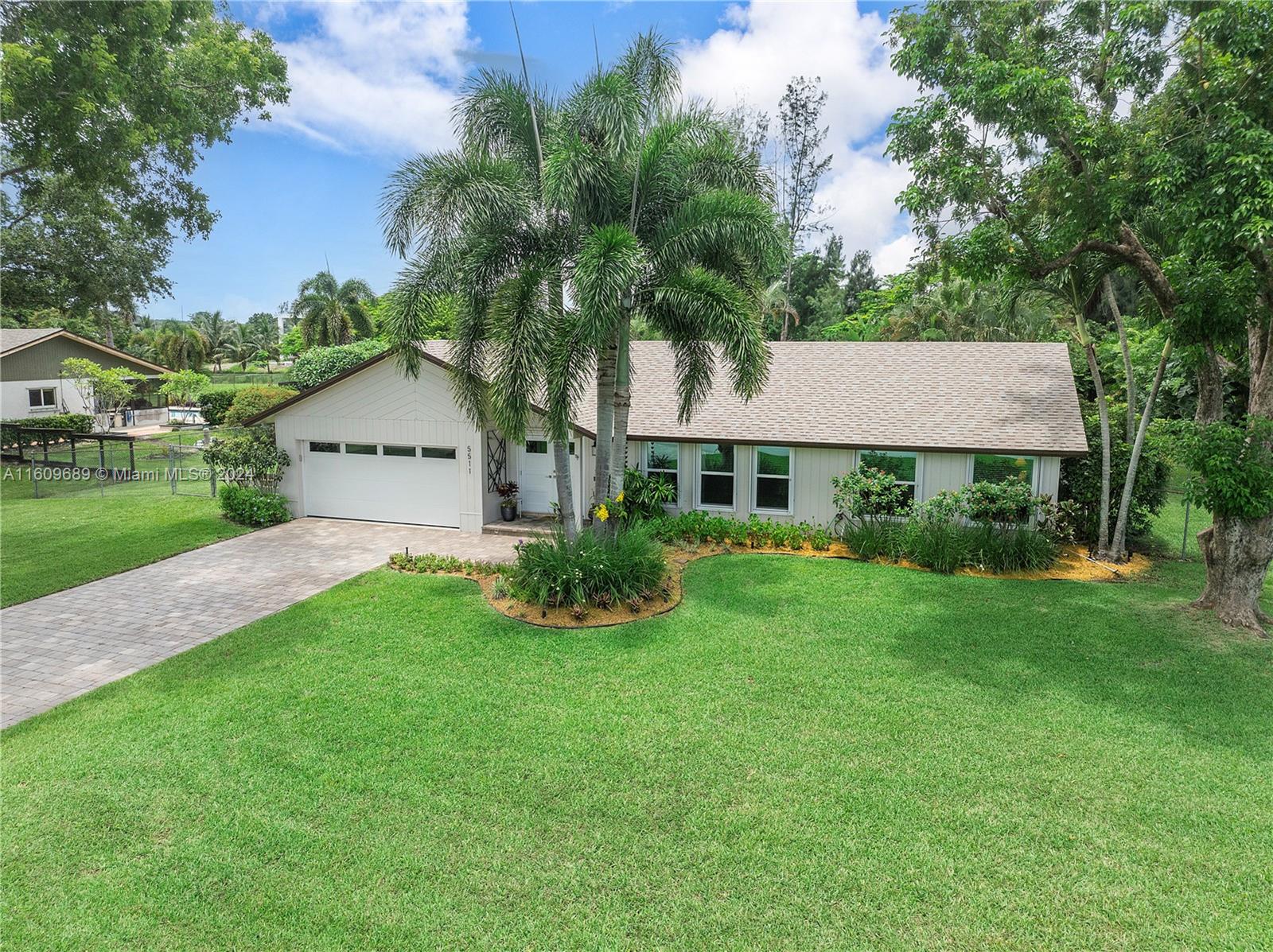 5511 Southwest 196th Lane Southwest Ranches, FL 33332 - Photo 89 of 94 a view of a house with a yard