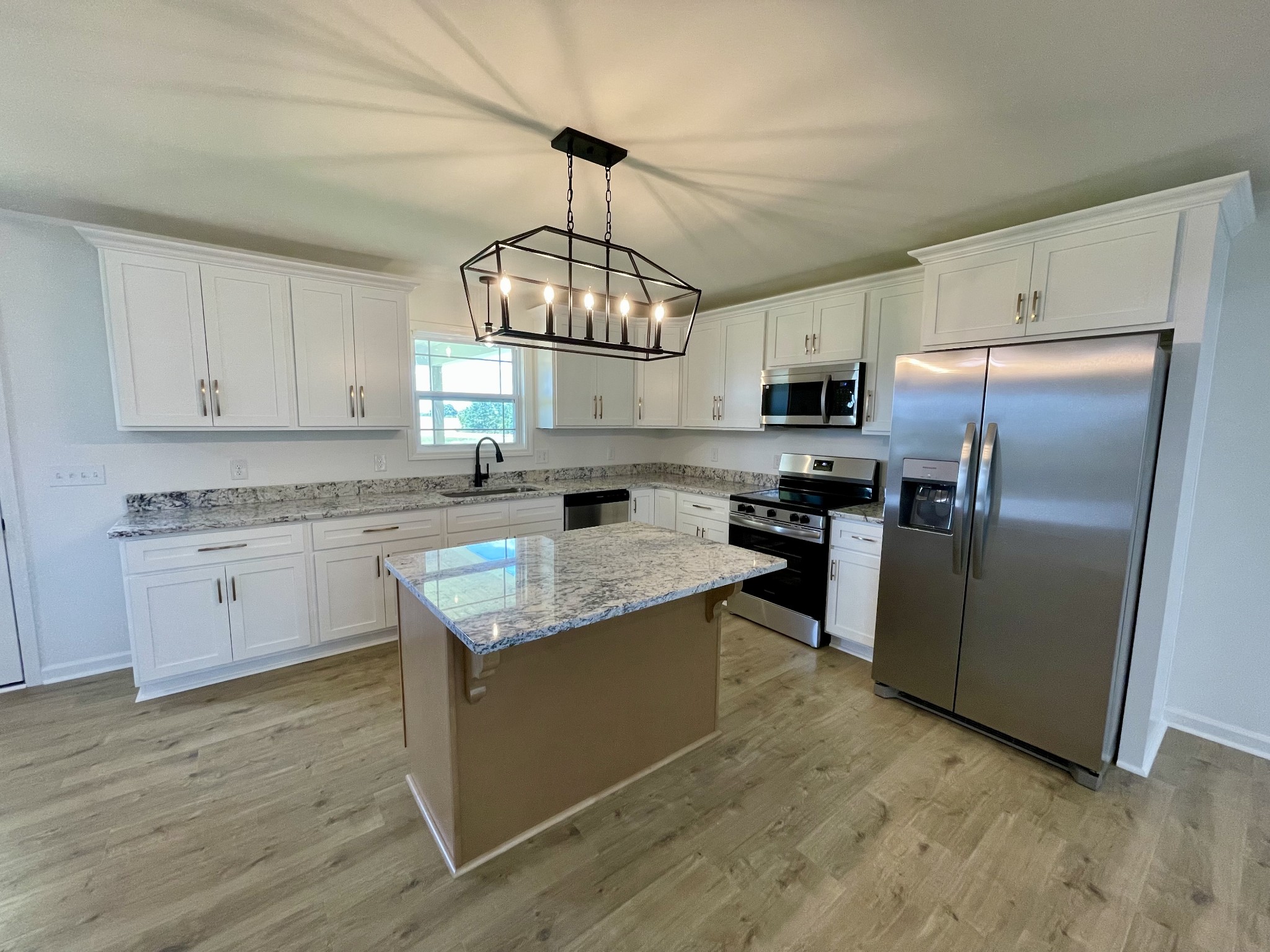 104 Donald Road Lafayette, TN 37083 - Photo 7 of 22 a kitchen with granite countertop stainless steel appliances cabinets a sink and a counter top space