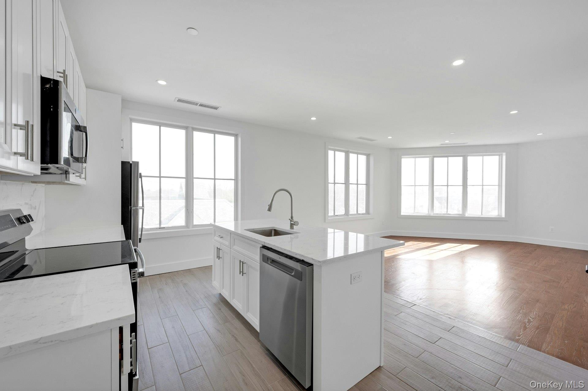 a kitchen with granite countertop a stove and a sink