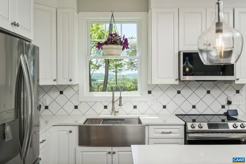 a kitchen with stainless steel appliances granite countertop a sink dishwasher and cabinets with wooden floor
