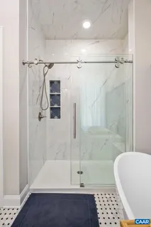 a view of a bedroom with a bed and a chandelier